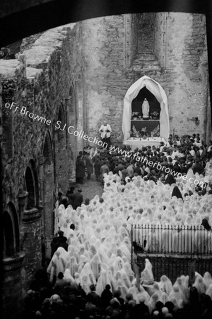 CEREMONY NAVE OF CHURCH FROM TOWER WINDOW(TELE) (FR.HALPIN S.J. PEACHING)